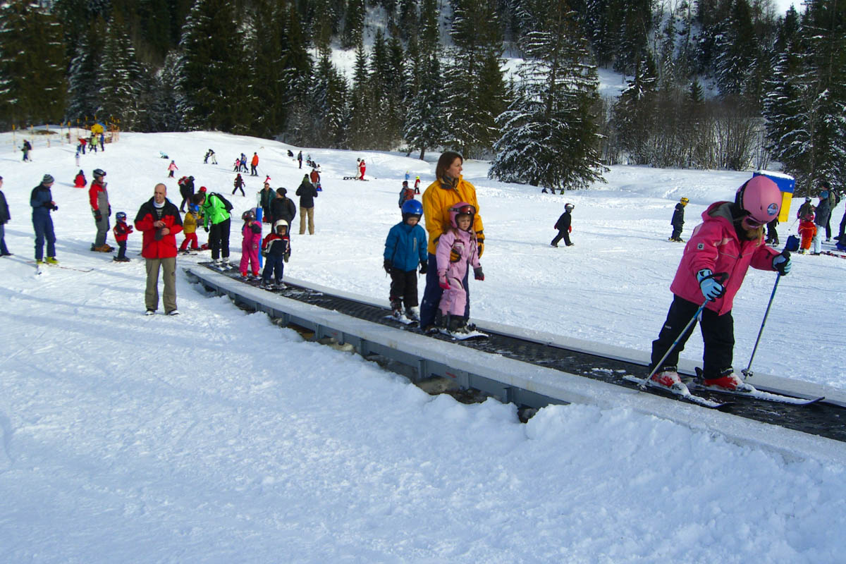 Sattel-Hochstuckli in Switzerland - a group of people skiing down a snowy hill.