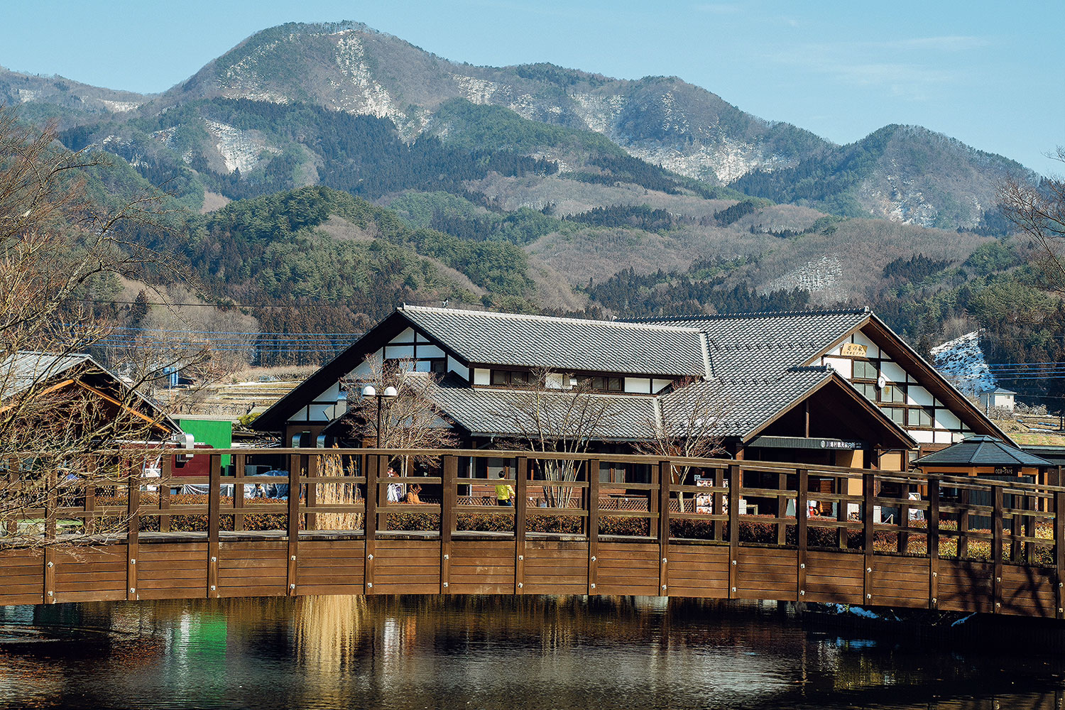 Kawaba in Japan - a bridge over a body of water with a mountain in the background.