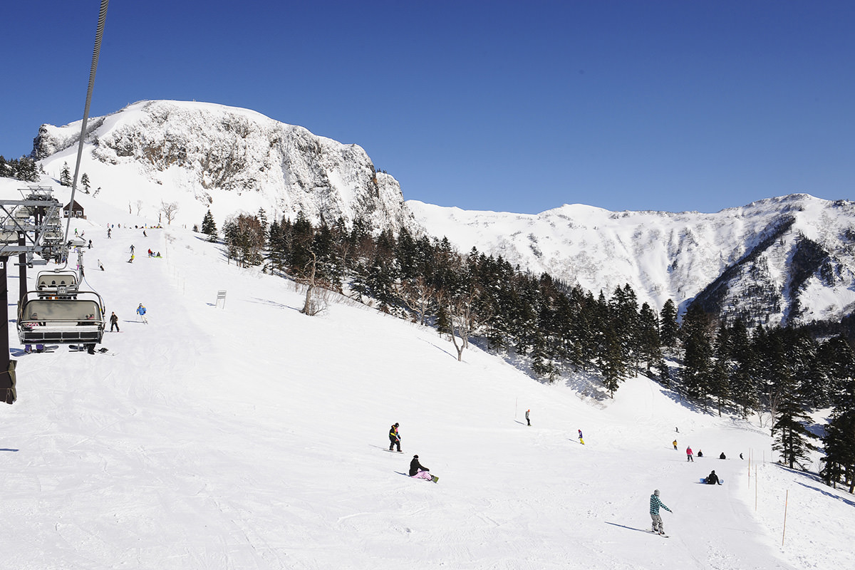 Kawaba in Japan - a group of people skiing down a snowy slope.