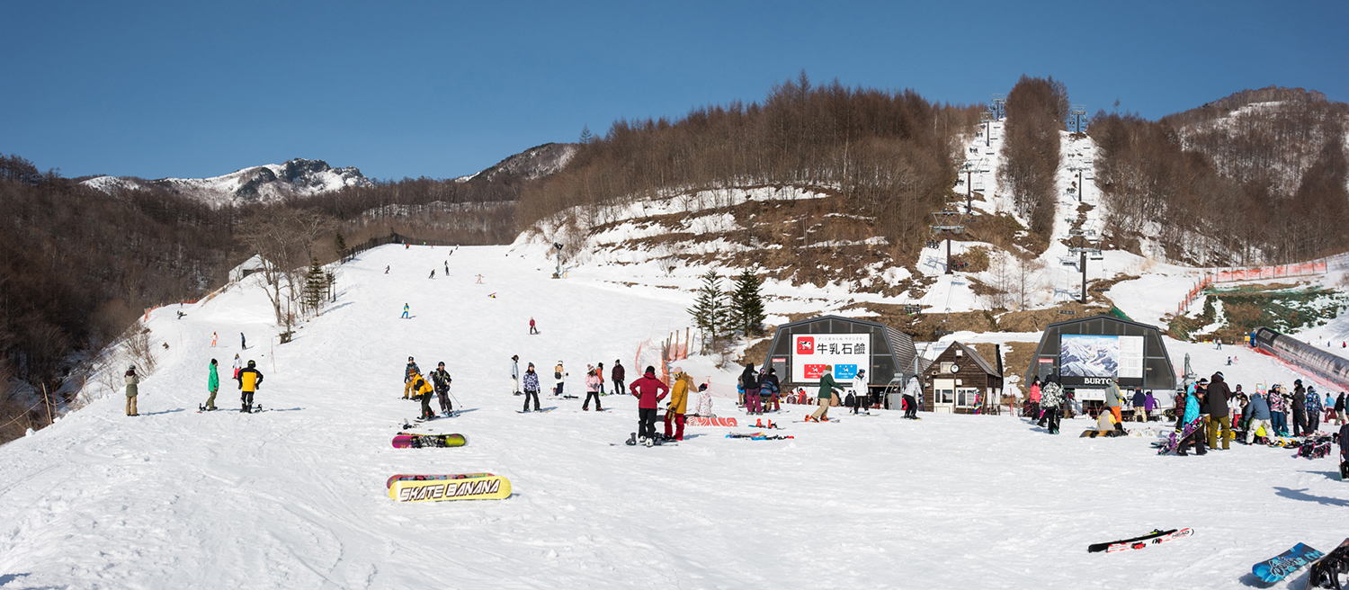 Kawaba in Japan - a group of people skiing down a snowy hill.