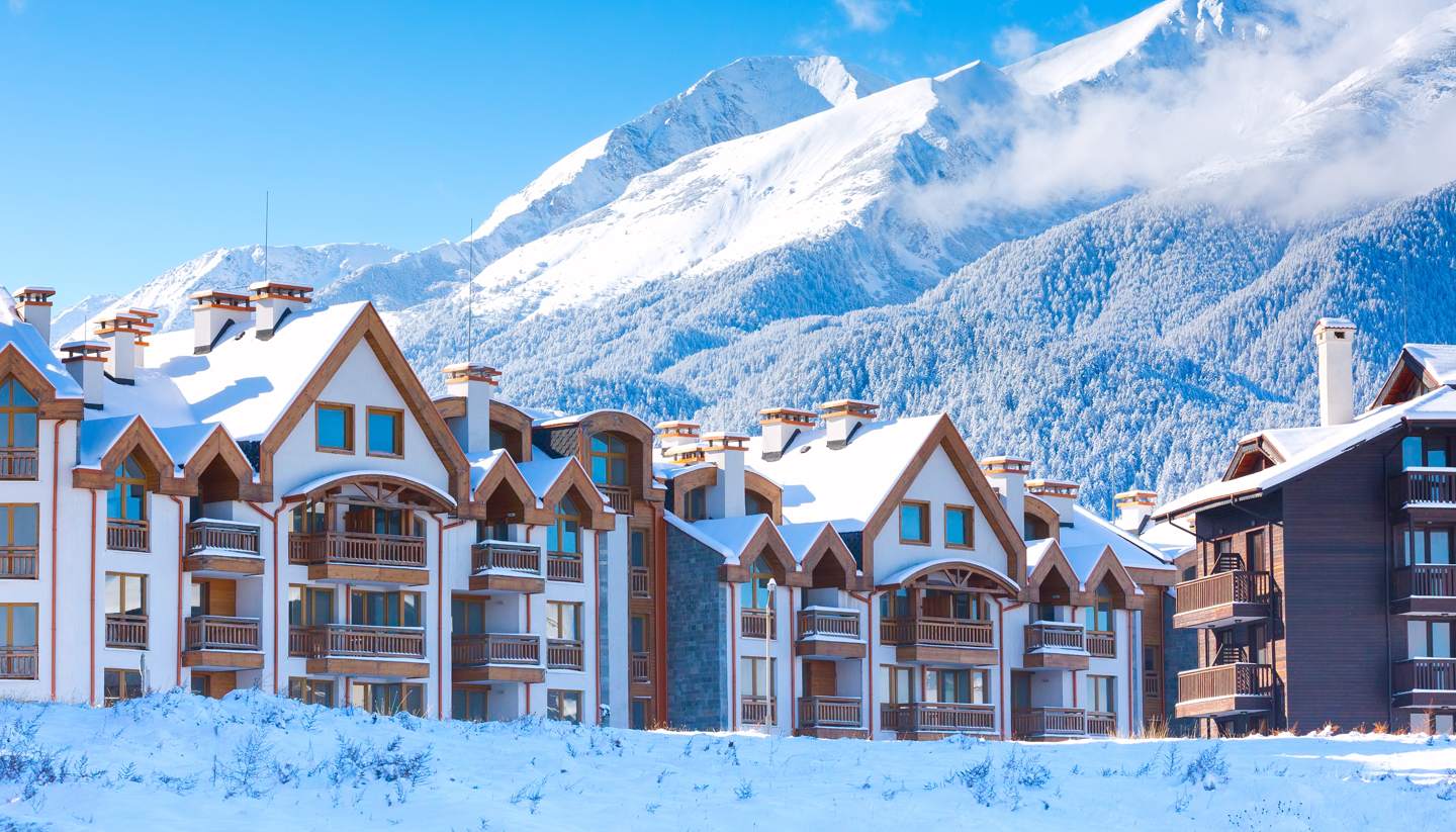Bansko in Bulgaria - a row of houses covered in snow.