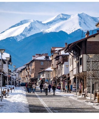 Image showcasing a picturesque chalet at the vibrant Bansko ski resort in Bulgaria. The stunning winter scenery captures a bustling winter sports scene amidst a sublime backdrop of pristine snow.