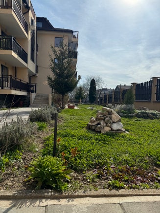 A charming chalet stands amidst a sunny day in Bansko, renowned as a ski resort town located in Blagoevgrad, Bulgaria.