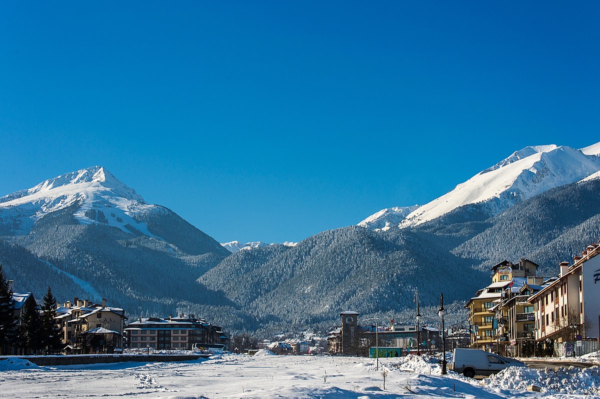 Bansko in Bulgaria - a snowy town with mountains in the background.