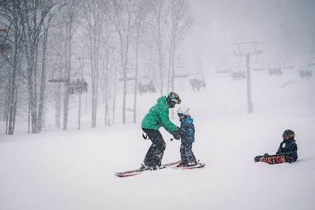 A snowboarder glides down the snowy slopes of Mont Rigaud in Quebec Canada surrounded by a pristine wintry landscape.