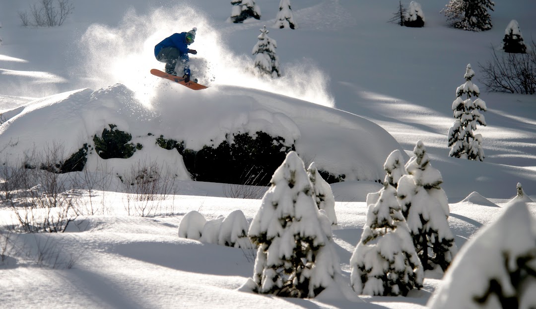A snowboarder shredding down the snowy slopes at Soda Springs in Lake Tahoe, California, demonstrating athleticism and adventure.