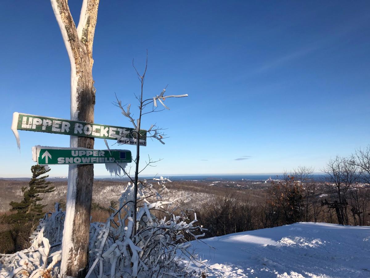 Marquette Mountain in USA - a street sign on top of a snowy hill.