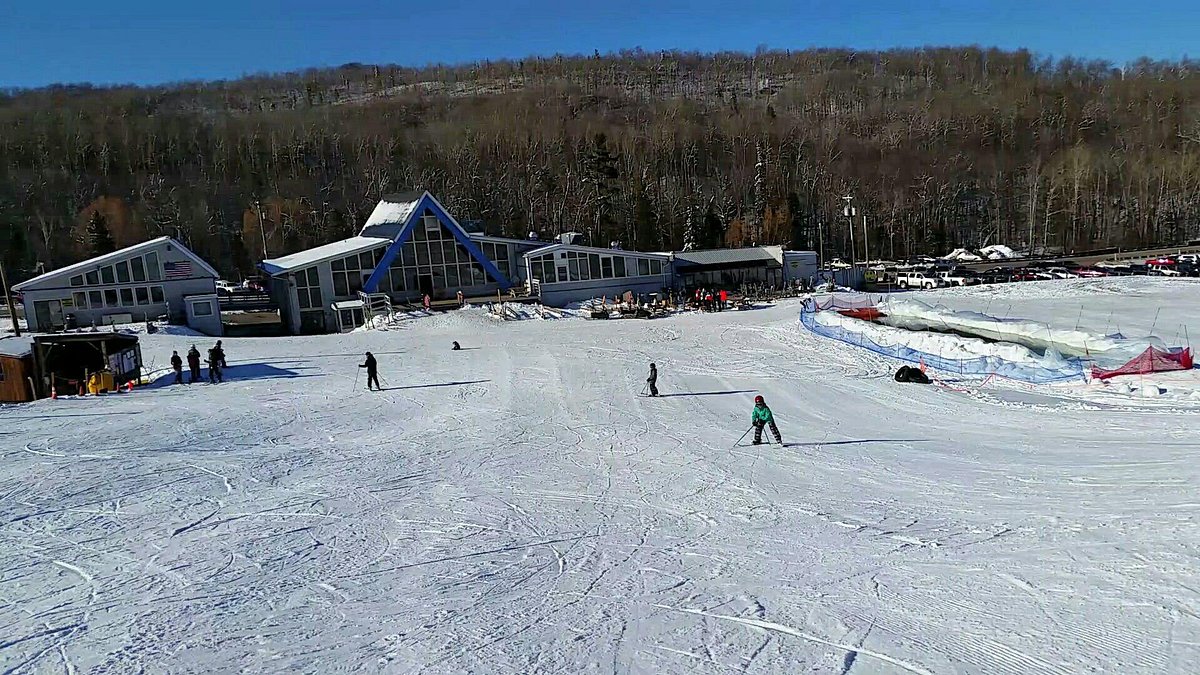 Marquette Mountain in USA - a group of people skiing down a snow covered hill.
