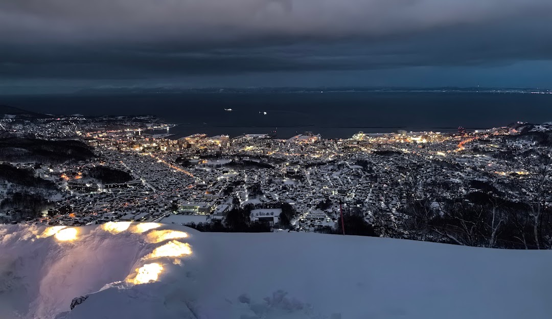 Winter scene at Moiwayama Ski Jominamishamen in Kitanosawa, Japan, featuring snowy mountain landscapes, winter sports activities, and a cozy chalet.