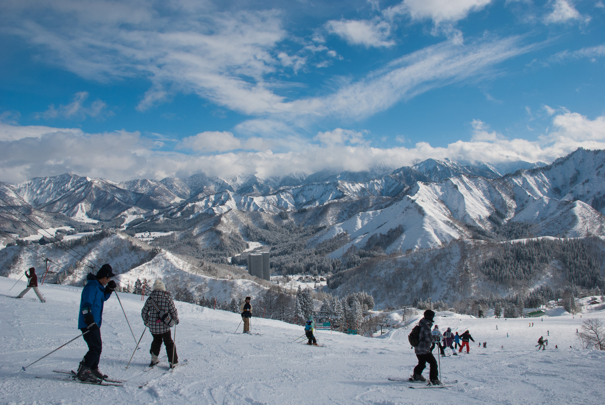 Naspa Ski Garden in Japan - a group of people skiing down a mountain.