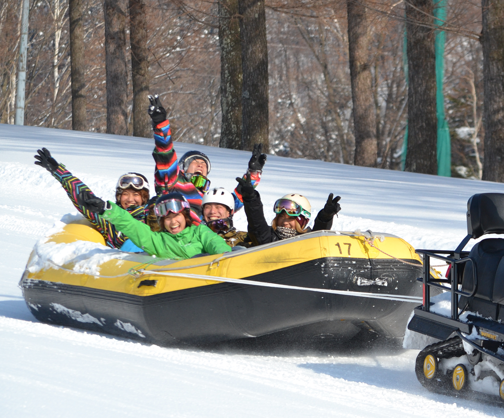 Naspa Ski Garden in Japan - a group of people riding on a snowmobile.