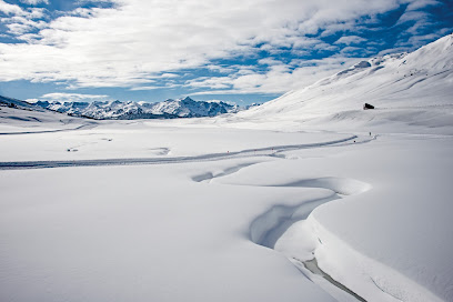 Winter sports scene at Baqueira Beret in Catalonia, Lleida, Spain featuring a stunning winter scenery with a chalet nestled against a snowy mountain backdrop.