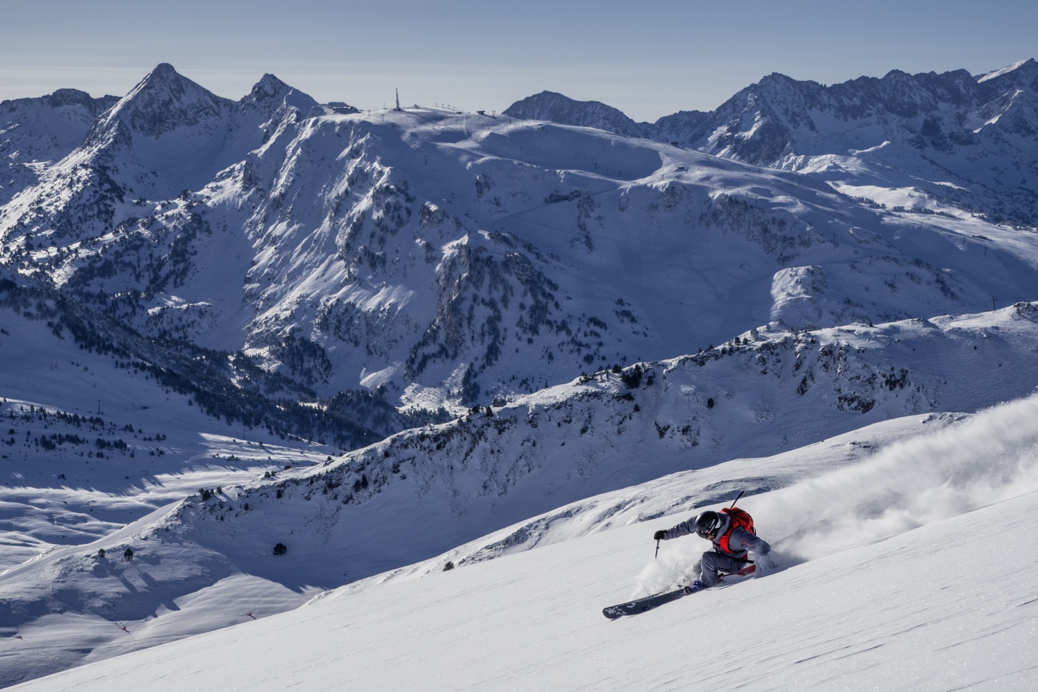 Baqueira Beret in Spain - a person skiing down a snowy mountain.