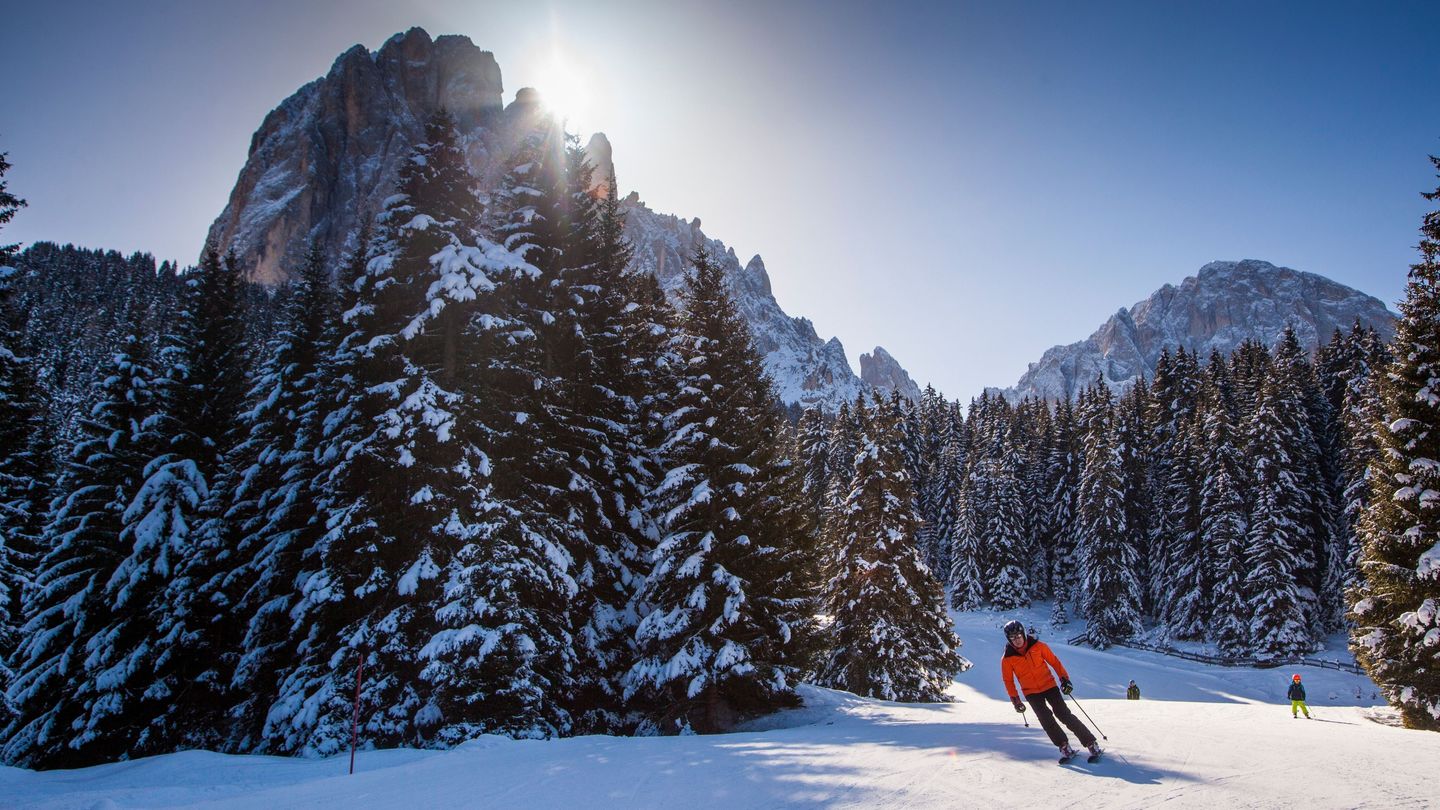 Val Gardena in Italy - a person skiing down a snow covered mountain.