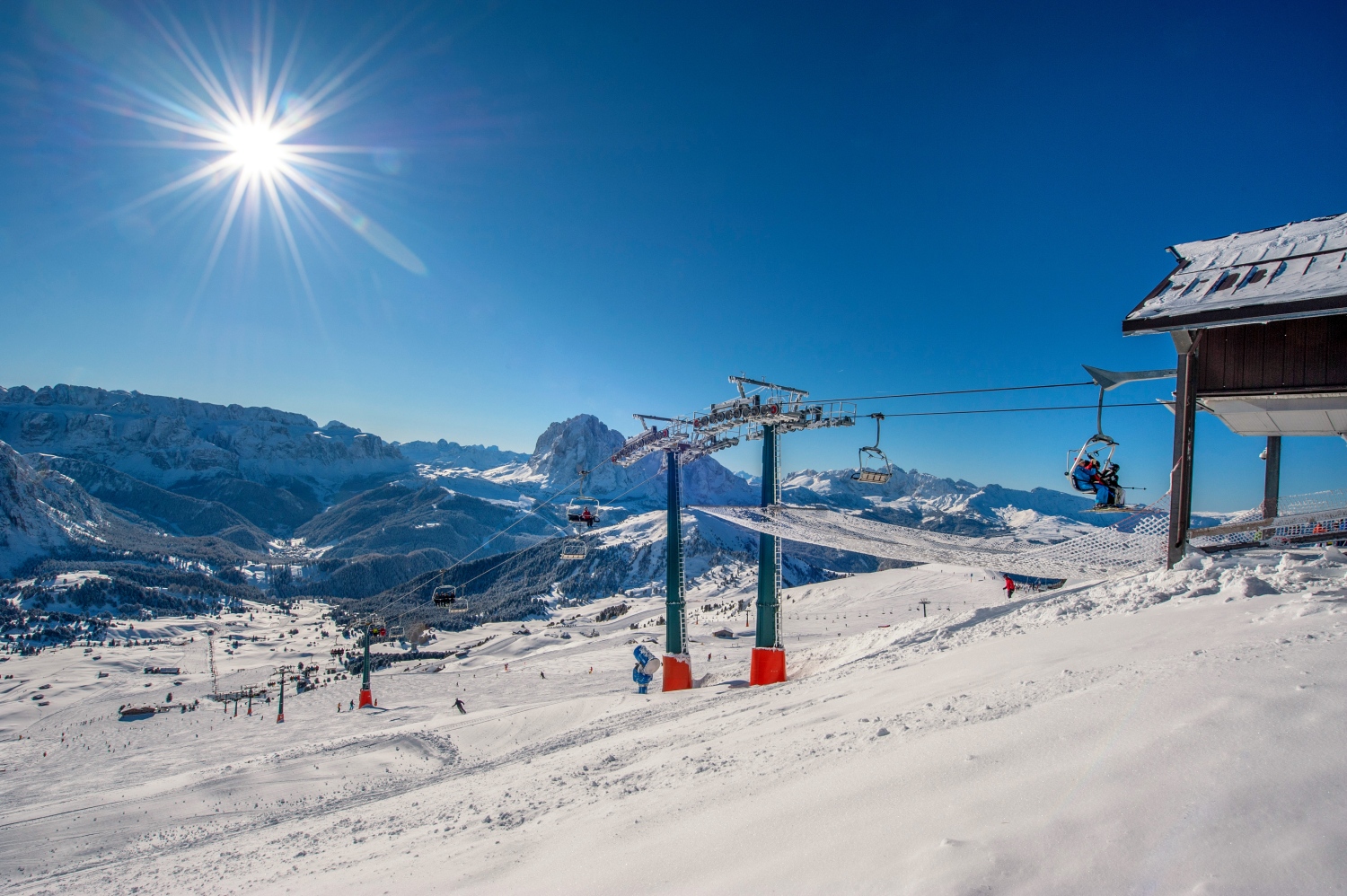 Val Gardena in Italy - a ski lift going up a snowy hill.