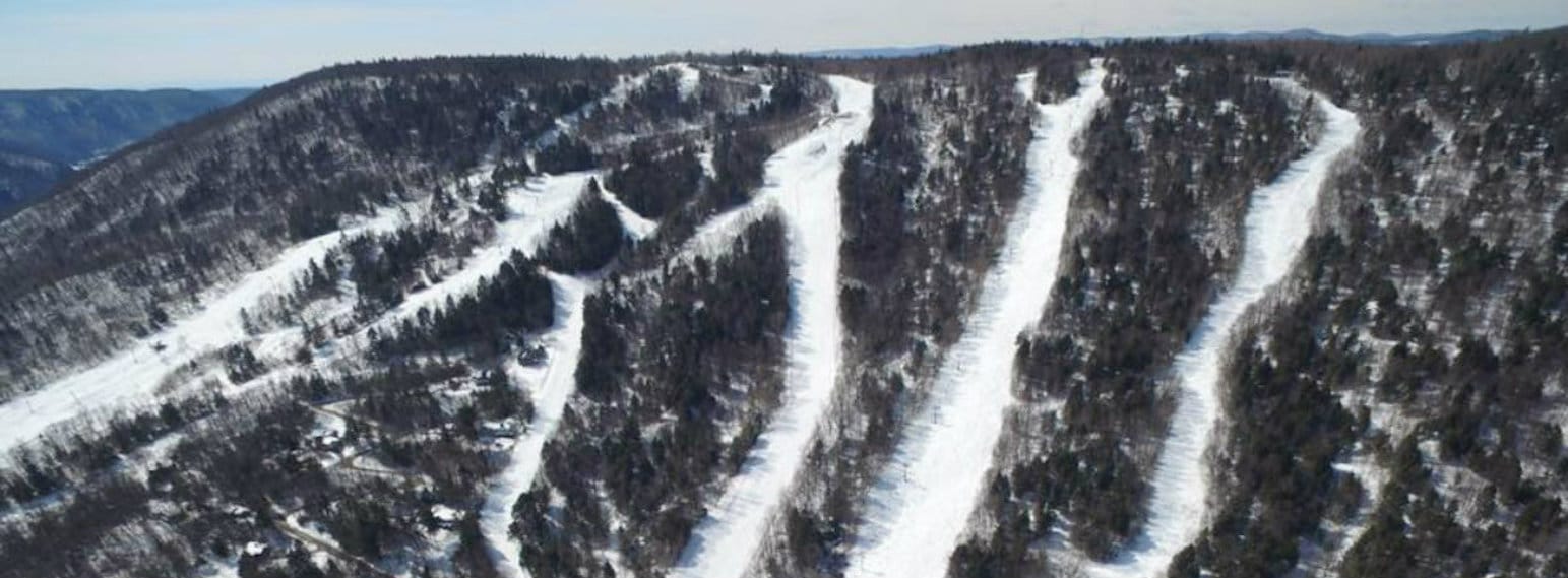 West Mountain in USA - a ski slope in the mountains with snow on it.