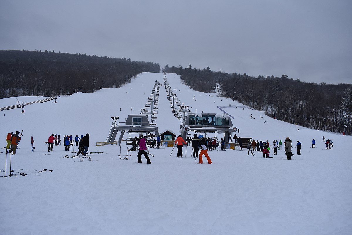 West Mountain in USA - a group of people standing on top of a ski slope.