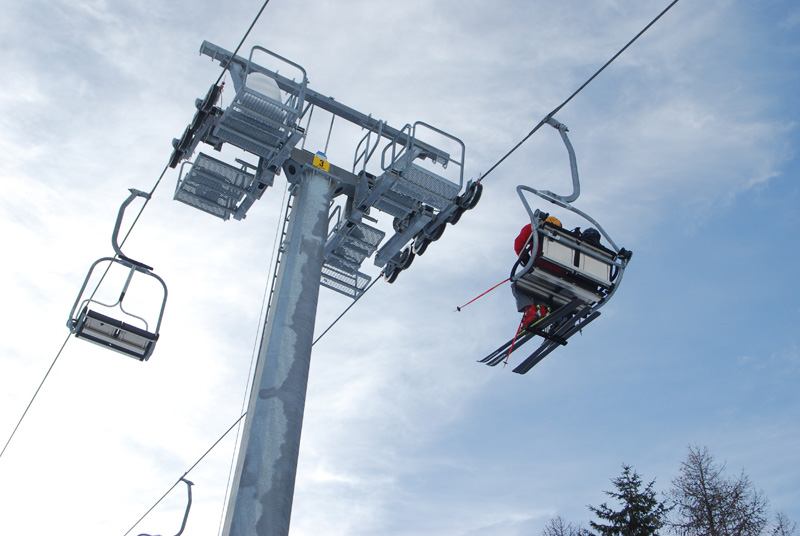 Ski lift ascending on snowy slopes at Cogne - Gran Paradiso in Italy, representing a picturesque winter sports scene at a ski resort.