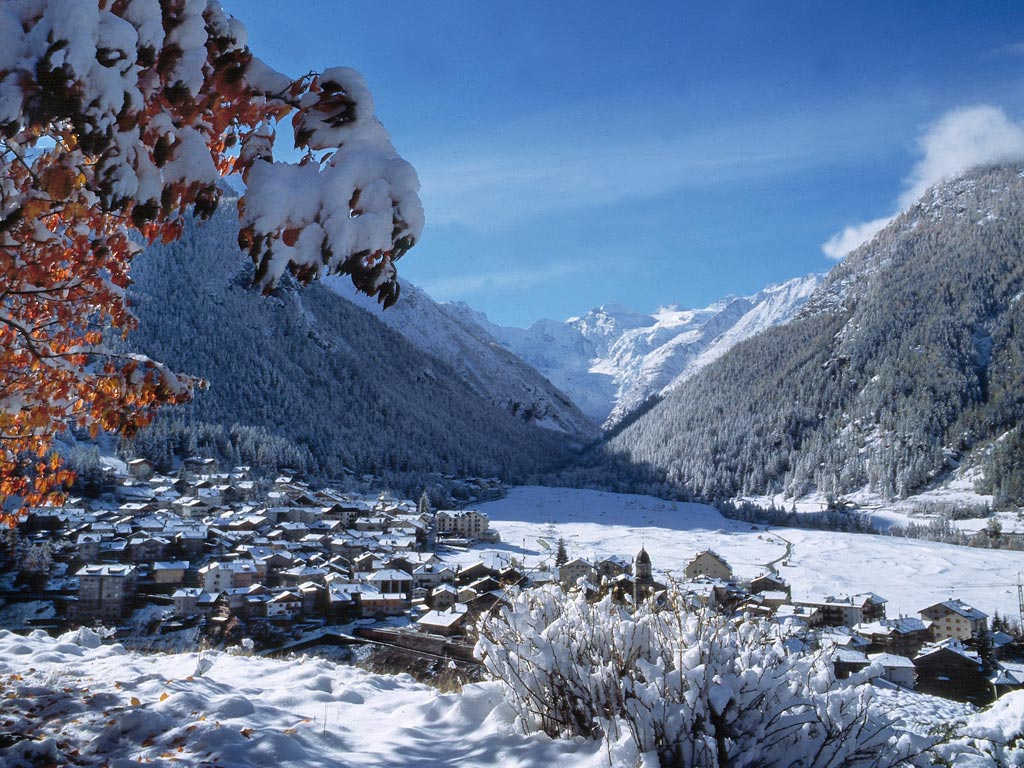 Winter scene at Cogne – Gran Paradiso in Italy, featuring stunning snow-filled landscapes, a cozy chalet, and a bustling winter sports centre.