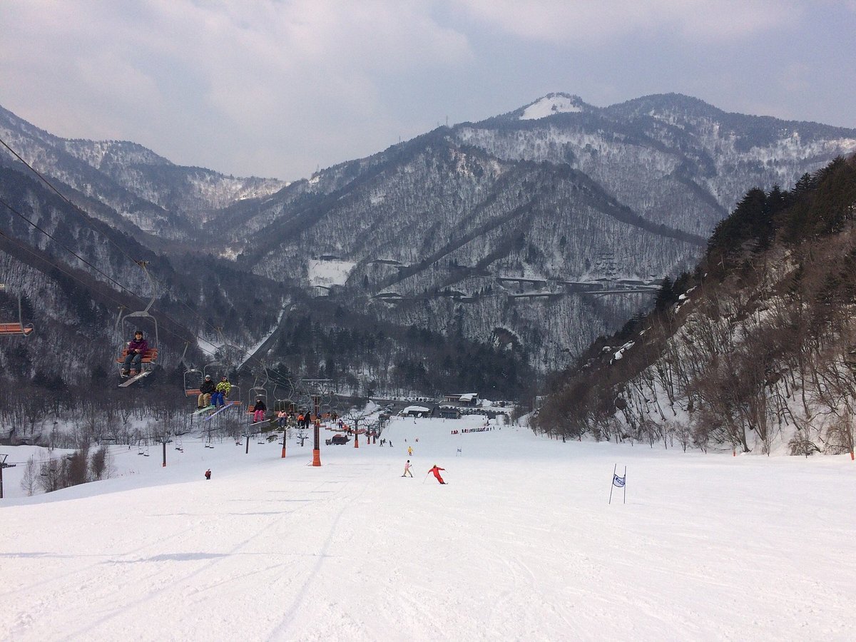Honokidaira in Japan - a ski slope with people skiing down it.
