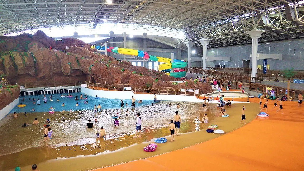 Rewild Ninja Snow Highland in Japan - a large indoor water park with lots of people.