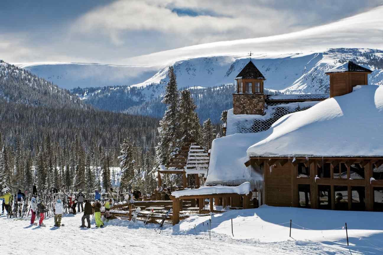 Winter Park Resort in USA - a group of people skiing down a snowy slope.