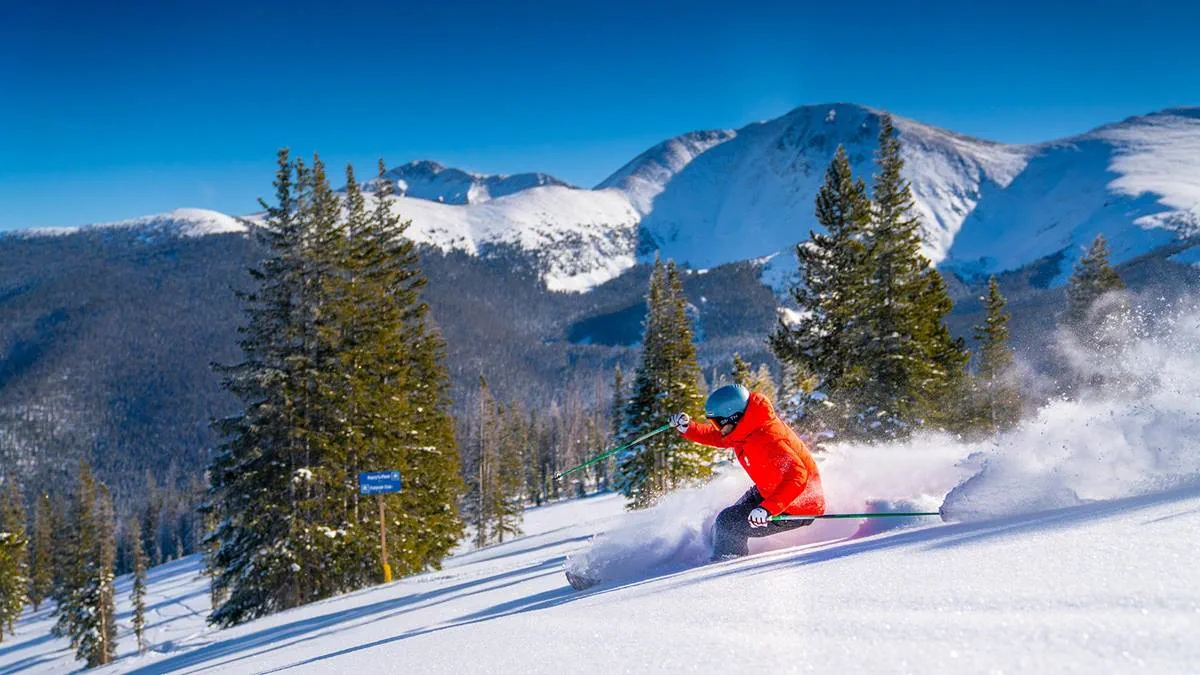 Winter Park Resort in USA - a skier skiing down a slope in the mountains.