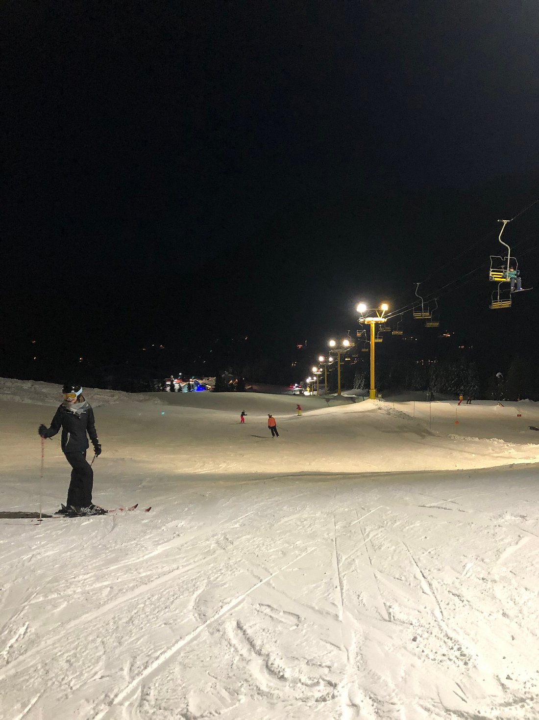 A skier enjoying a day on the slopes at Sasquatch Mountain a ski resort in Hemlock Valley Agassiz British Columbia Canada. A ski lift and a chalet are in view.