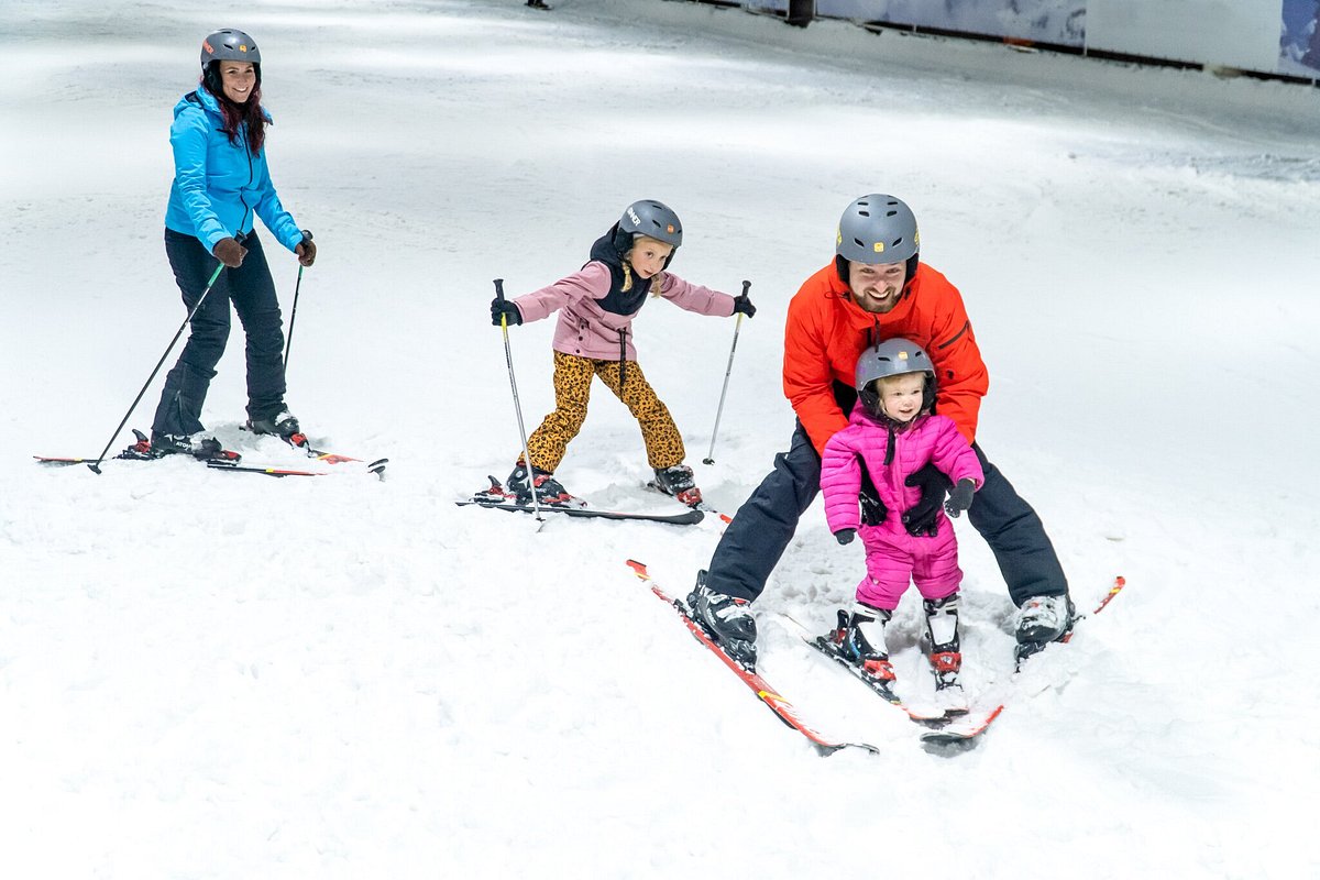 SnowWorld Rucphen in Netherlands - a group of people riding ski boards down a slope.