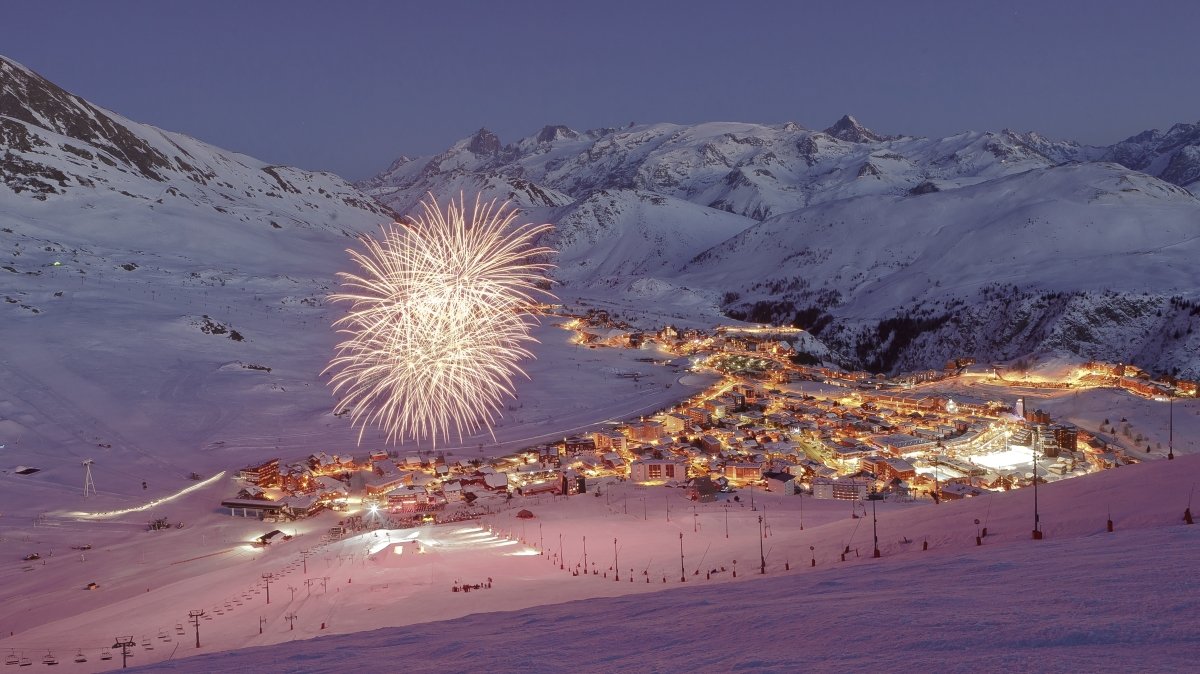 Alpe d'Huez in France: a fireworks is lit up the sky above a ski resort.
