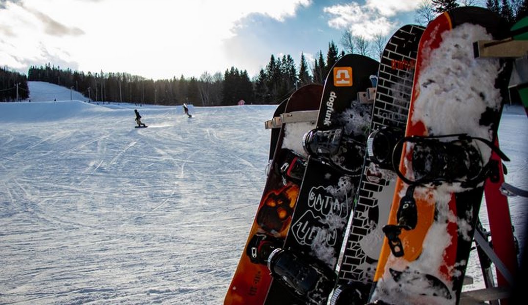 A snowboarder tackling the snowy slopes at Mont Farlagne, located in Saint-Jacques, New Brunswick, Canada.