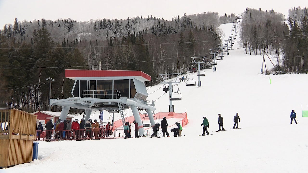 Mont Farlagne in Canada - a group of people standing on a ski slope.