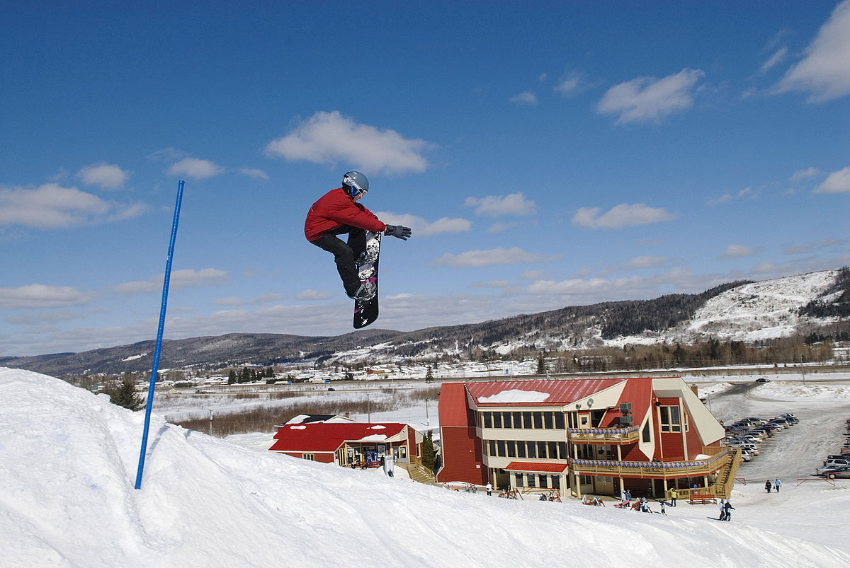 Mont Farlagne in Canada - a snowboarder doing a trick in the air.