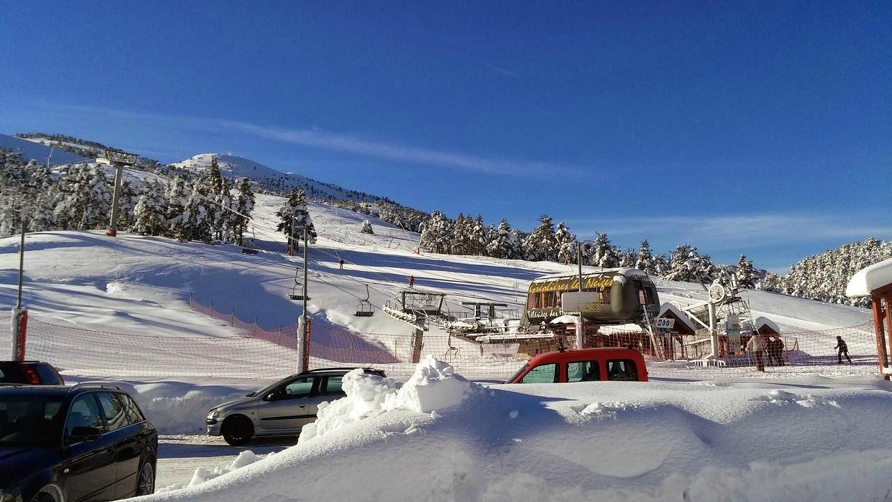 A vibrant scene of Gréolières Les Neiges ski resort in France, featuring a rustic chalet against the backdrop of a popular winter sports scene.