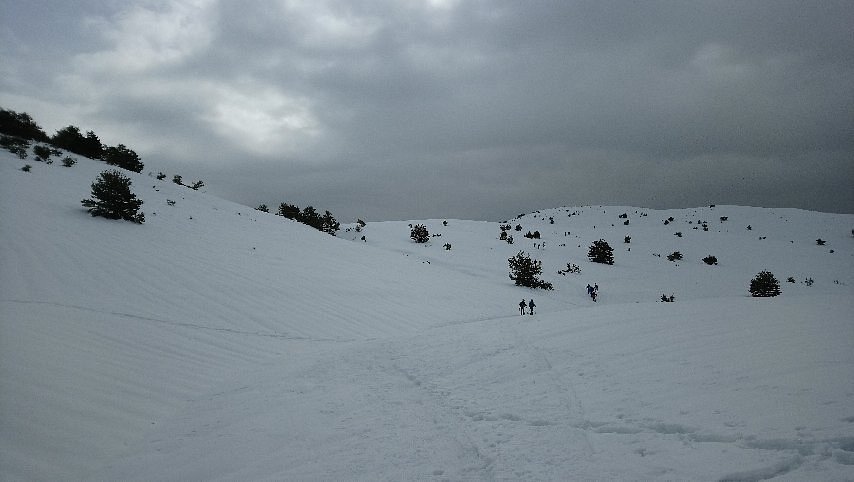 Winter scene at Gréolières Les Neiges in France, featuring a charming challet, bustling ski resort, and snow-covered slopes that host a variety of winter sports activities.