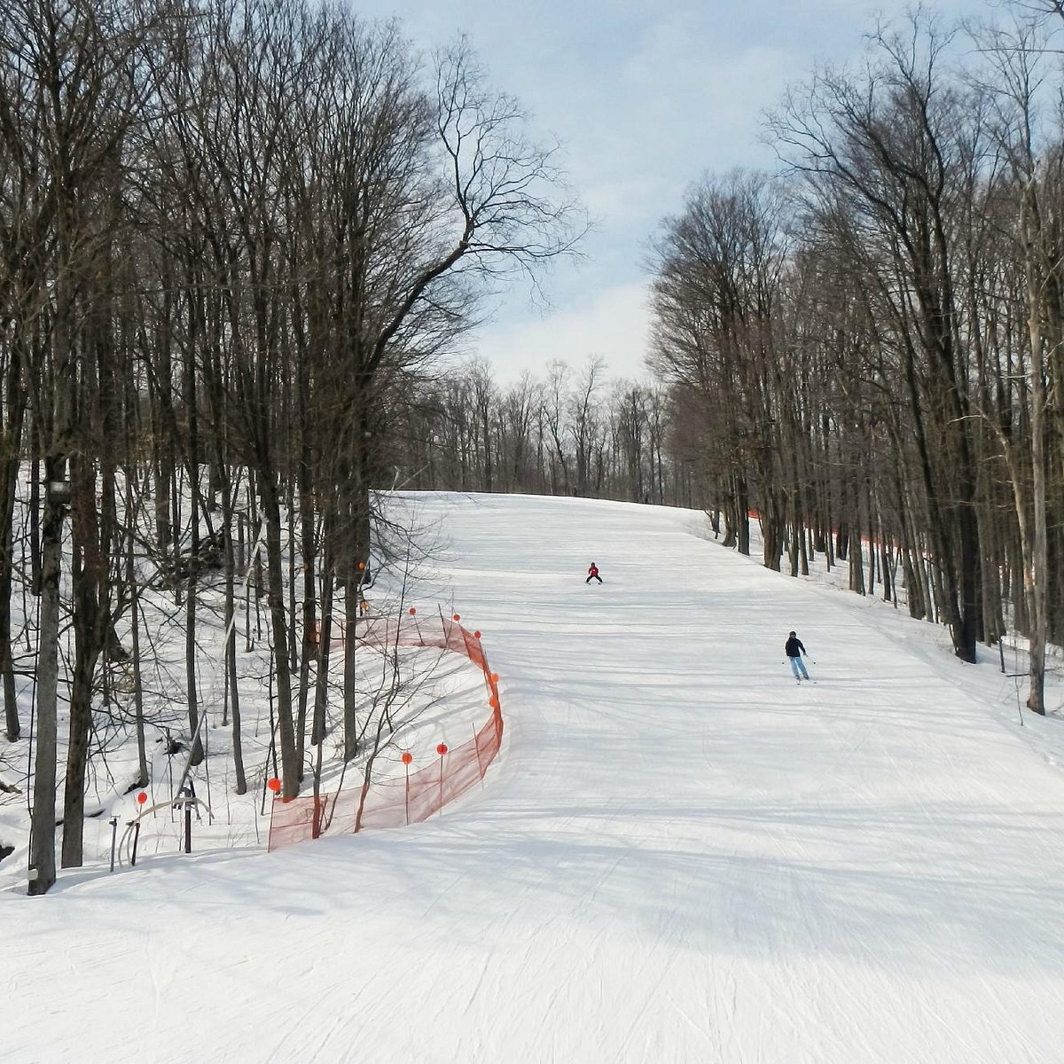 Peek n Peak in USA - a person on a snowboard going down a hill.
