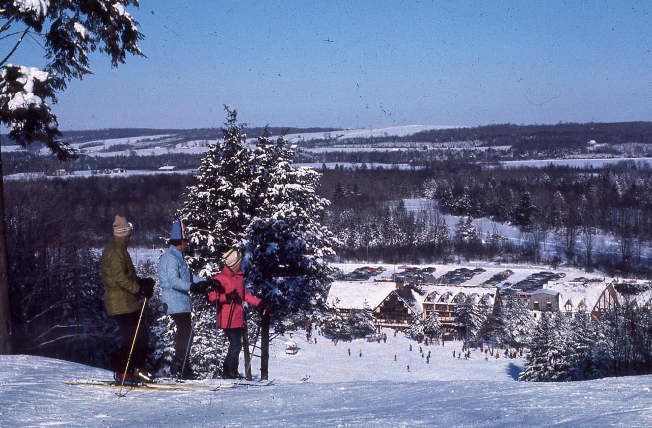 Peek n Peak in USA - a group of people standing on top of a snow covered hill.