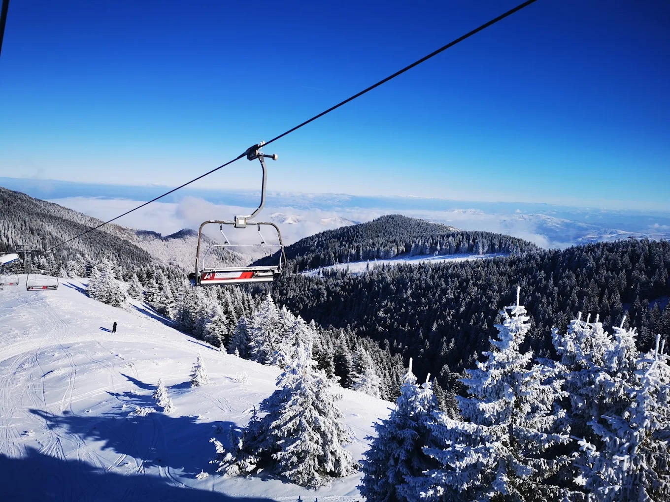 Kopaonik in Serbia - a ski lift going up a snowy mountain.