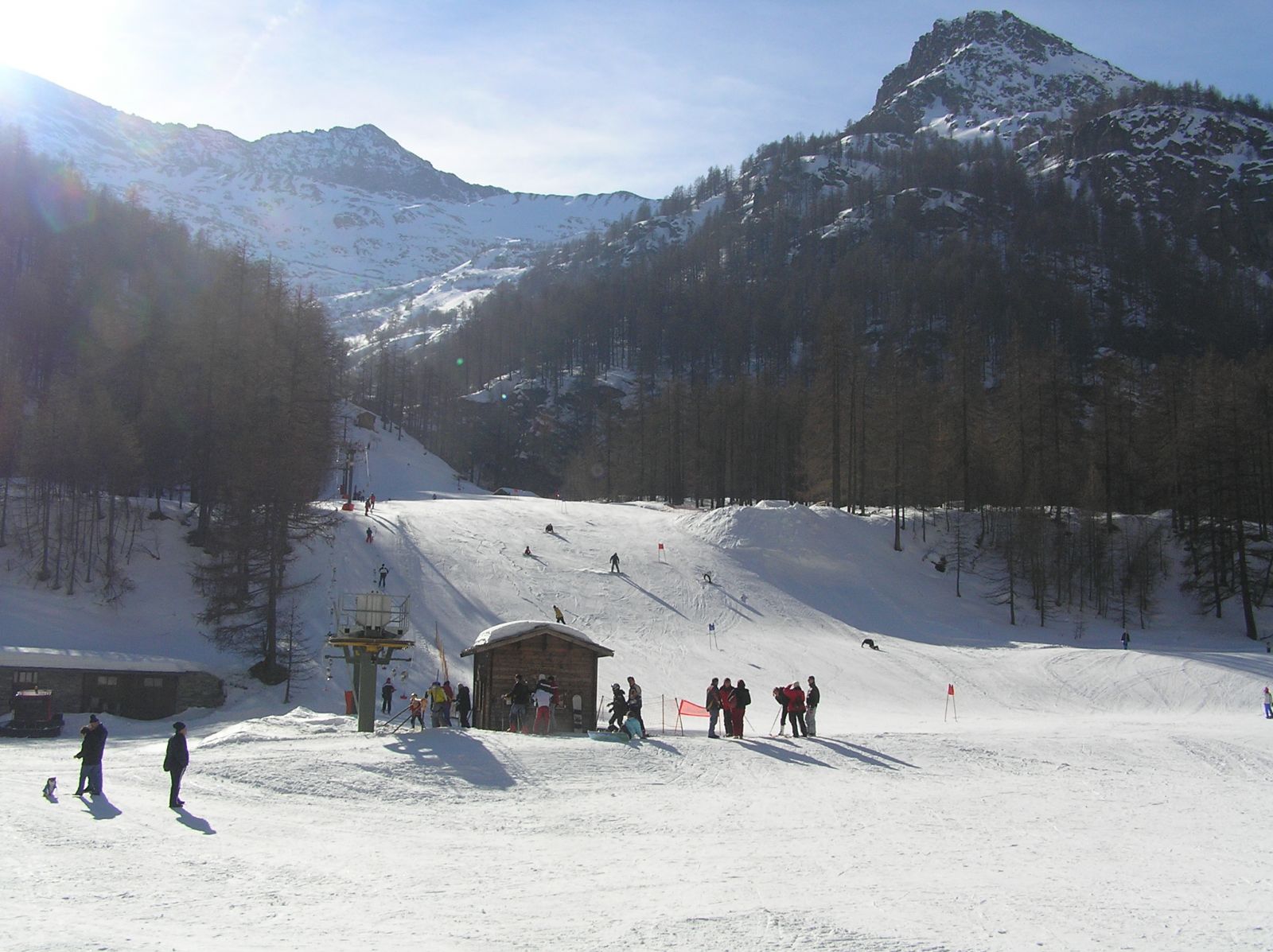 Ala di Stura in Italy - a group of people skiing down a snowy slope.