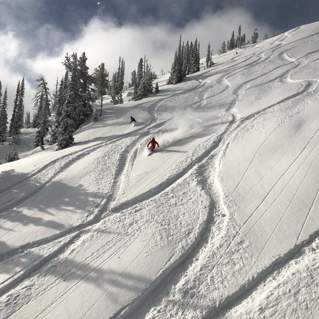 Anthony Lakes Mountain Resort in USA - a person skiing down a snow covered slope.