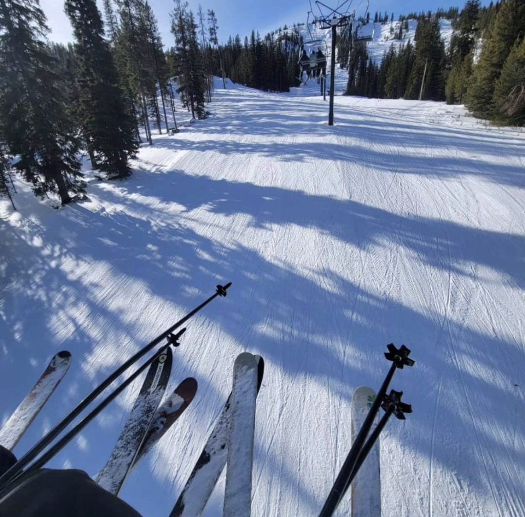 Anthony Lakes Mountain Resort in USA - a person riding skis down a snowy slope.