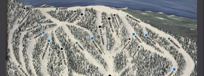 View of the snowy Anthony Lakes Mountain Resort in North Powder, Oregon, featuring a ski resort, a chalet in the distance, and a ski lift traversing the stunning, snow-covered mountain.