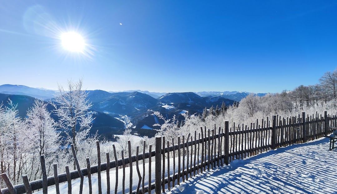 Winter panorama of Annaberg ski resort in Lower Austria, engrossed in a stunning winter scenery under a sunny bright sky showcasing pleasant winter sports scene.