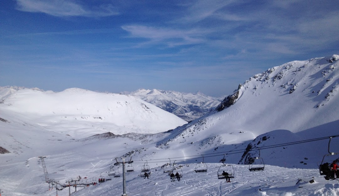 Image of Fuentes de Invierno in Spain, featuring a charming chalet with a bustling winter sports scene. The picturesque ski resort is surrounded by snow-covered slopes.