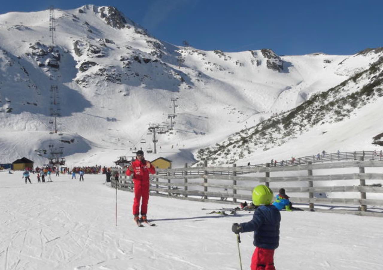 Fuentes de Invierno in Spain - a group of people skiing down a snow covered mountain.