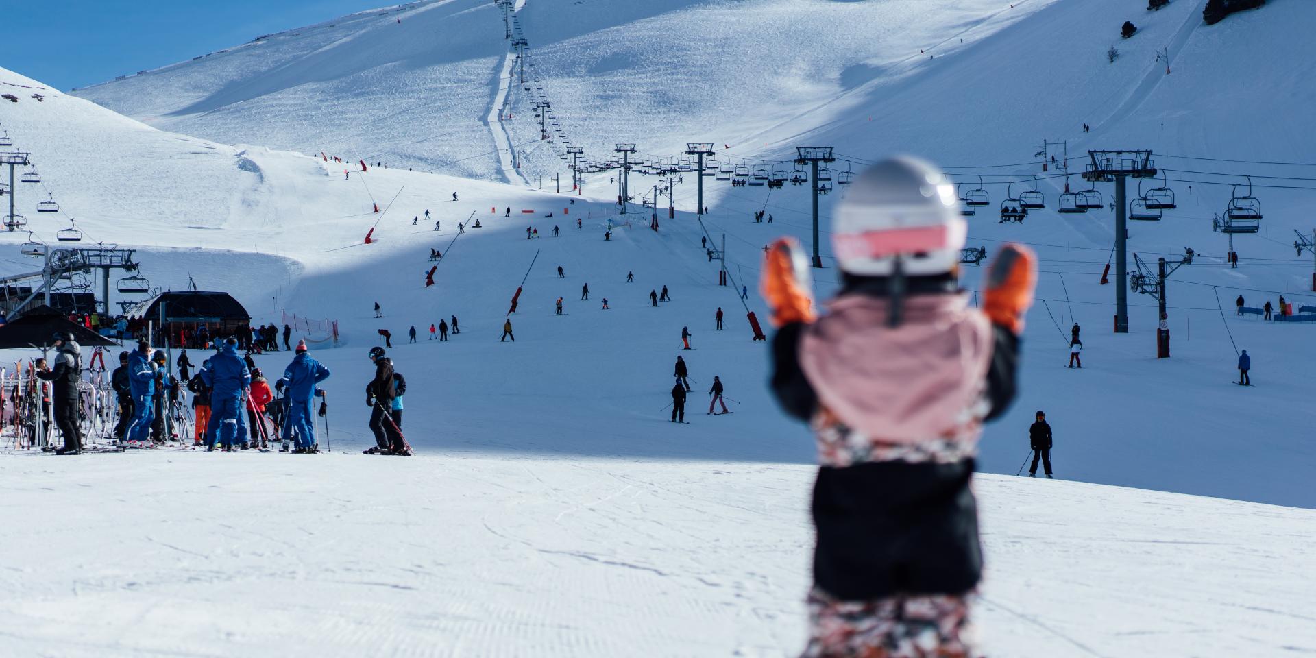 Saint-Lary-Soulan in France - a group of people skiing down a snowy hill.