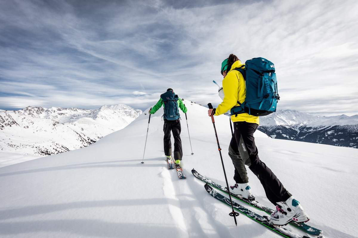 Saint-Lary-Soulan in France - two people skiing down a snowy mountain.