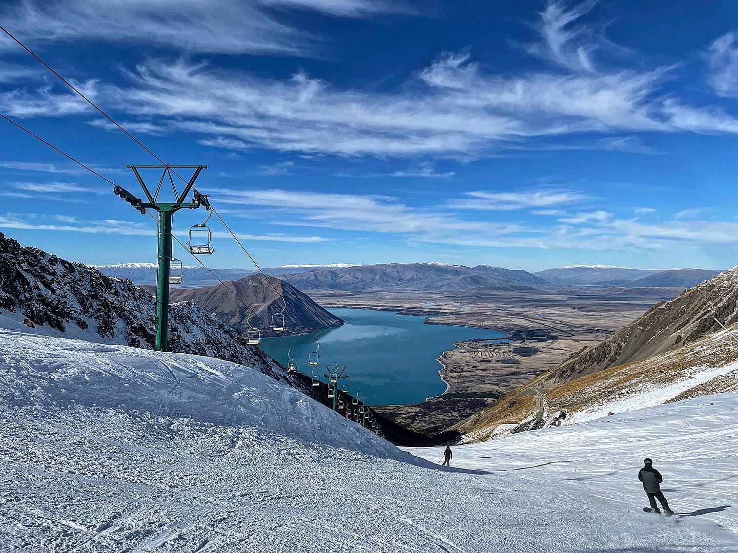 Ohau in New Zealand - a person skiing down a snow covered mountain.
