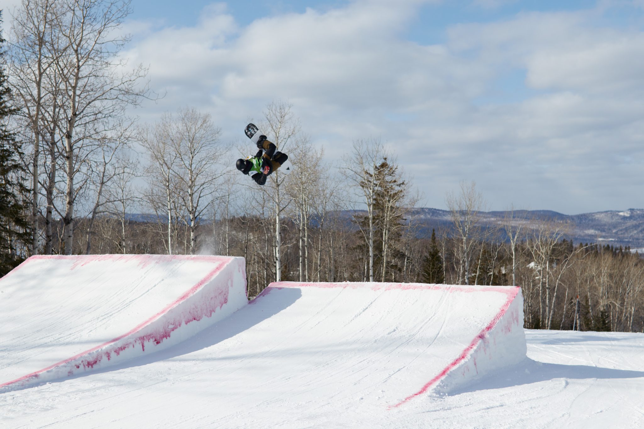 A snowboarder is carving down a slope at Sugarloaf Provincial Park in Atholville New Brunswick Canada a ski resort immersed in winter sports activities.