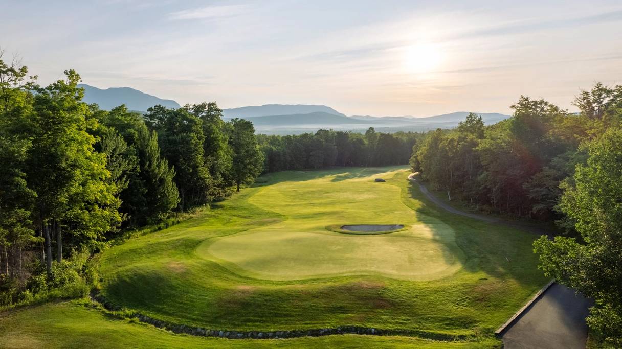 Sugarloaf Provincial Park in Canada - a golf course surrounded by trees and mountains.